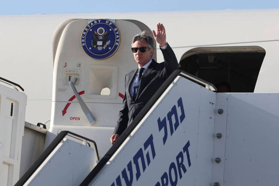 U.S. Secretary of State Antony Blinken waves as he arrives at Ben Gurion airport near Tel Aviv, ...