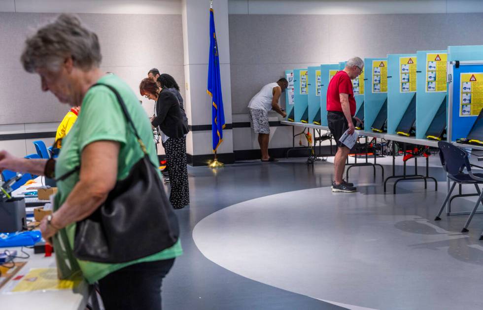 Voters sign in and cast their choices during Nevada's primary election day at the polls within ...