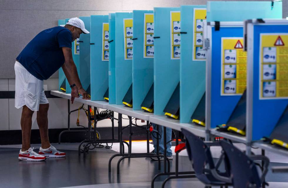 A voter makes his selections during Nevada's primary election day at the polls within the Summe ...