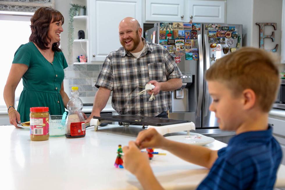 Brandon Eddy, center, laughs with his wife Lisa Eddy and son Mason while making pancakes for di ...