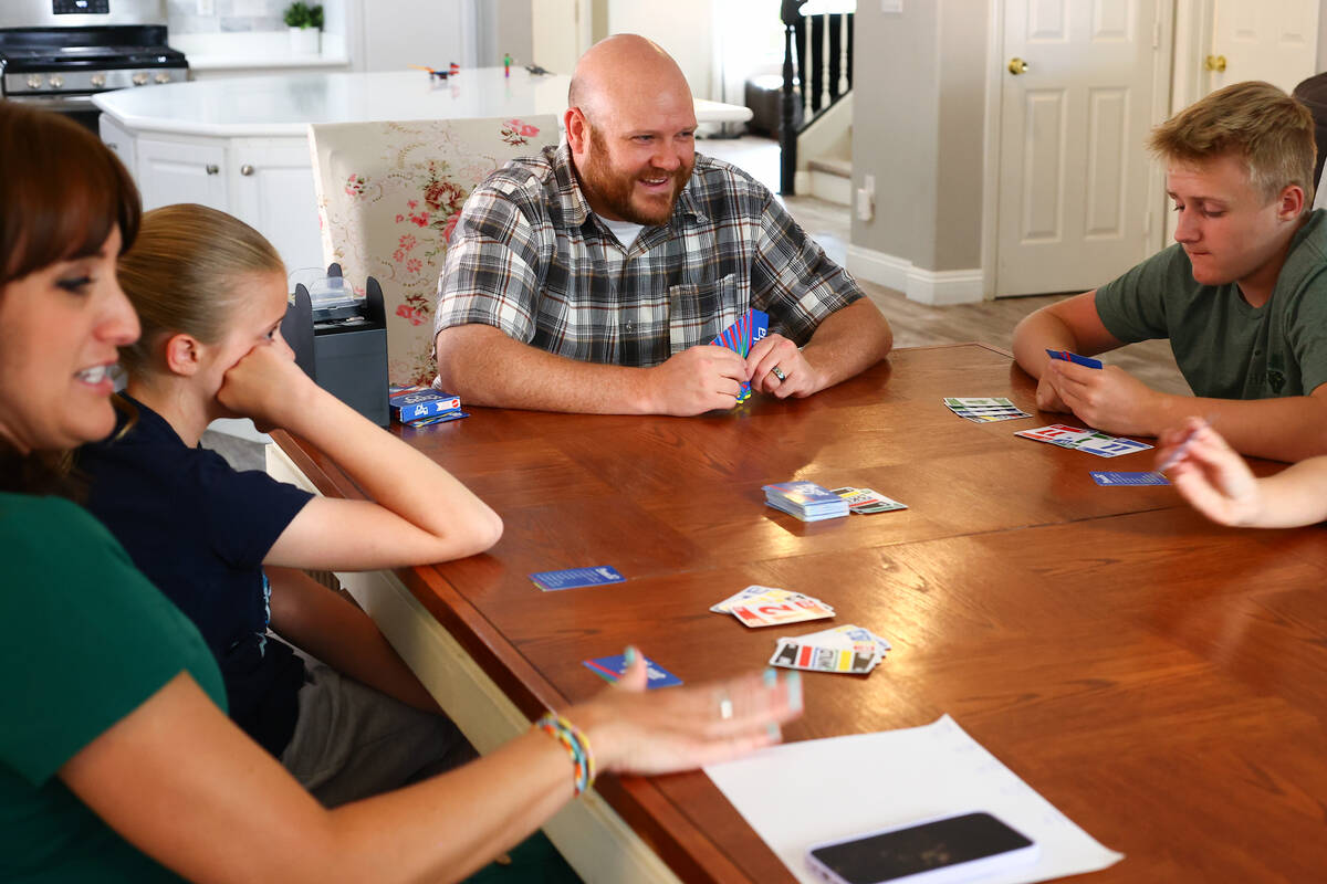 The Eddy family, from left, Lisa, Hannah, Brandon and Ryker, play a card game after dinner at t ...
