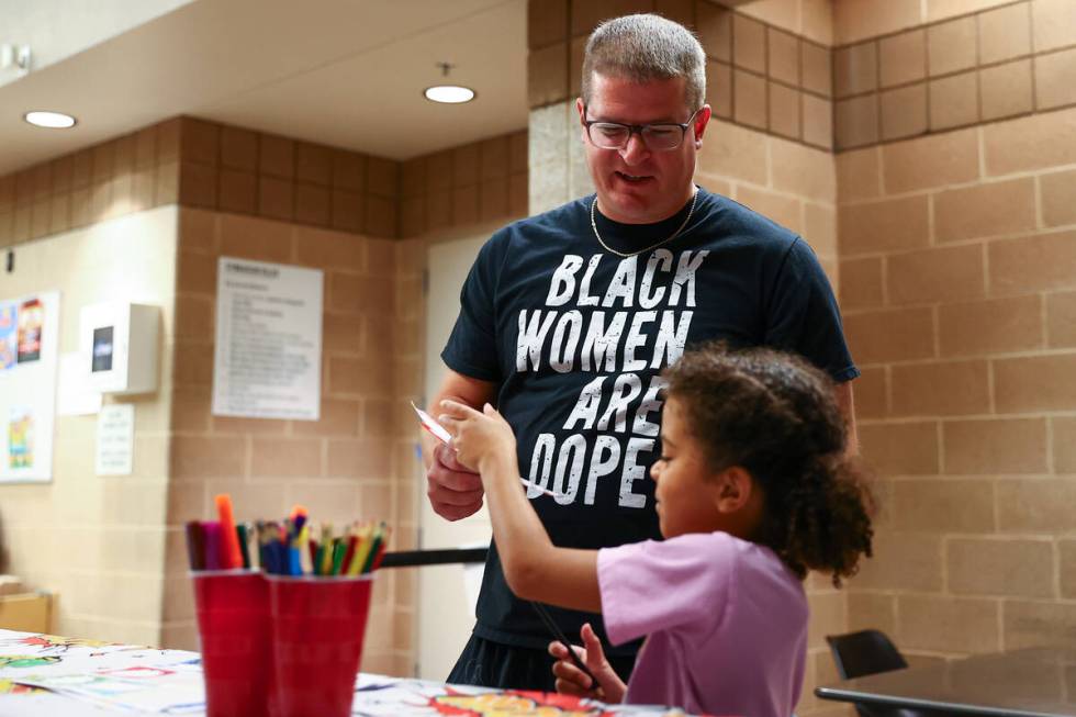 Dylann Hoover, 6, hands a craft she made to her father Eric Hoover, of North Las Vegas, during ...