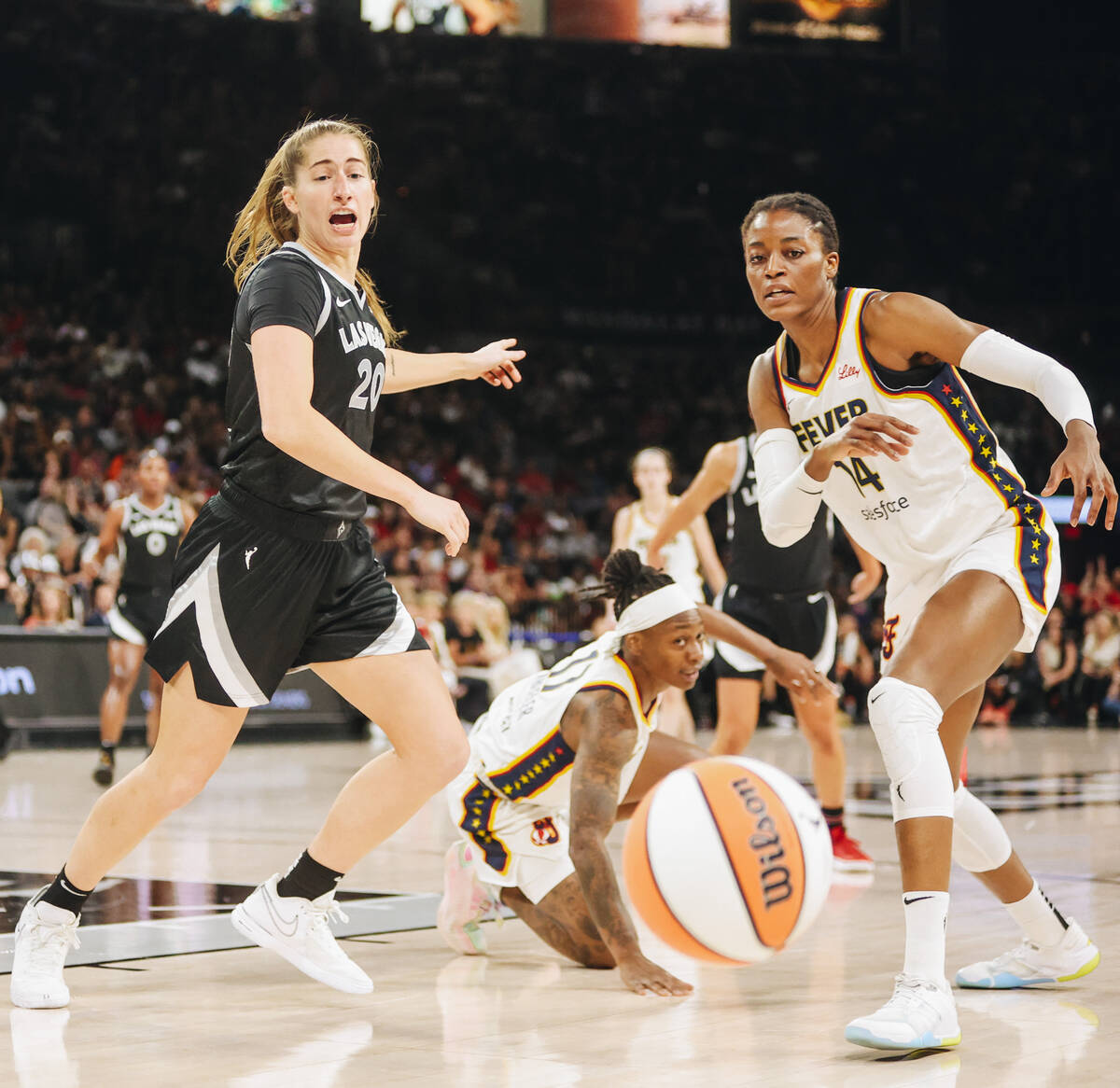 Aces guard Kate Martin (20) and Indiana Fever center Temi Fagbenle (14) run after the ball duri ...
