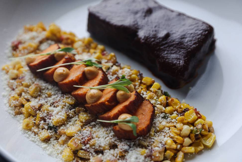 Beef short ribs with mole, roasted sweet potatoes and esquites at Aroma Latin American Cocina, ...