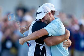 Wyndham Clark celebrates with his caddie after winning after the U.S. Open golf tournament at L ...