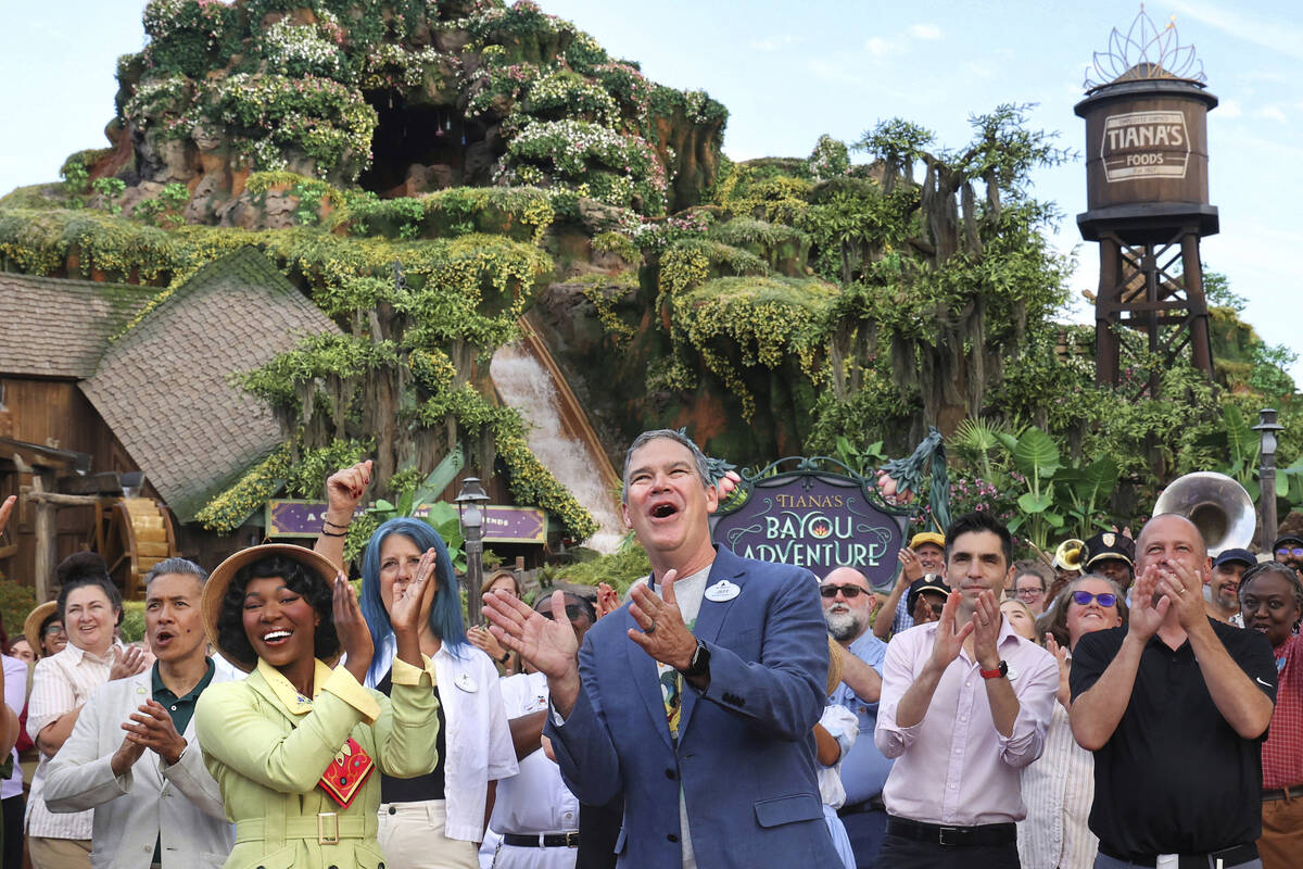 With Princess Tiana, Walt Disney World president Jeff Vahle cheers during a "Thank You Fête" h ...