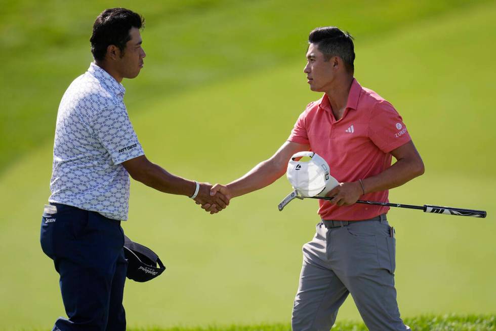 Hideki Matsuyama, left, and Collin Morikawa shake hands on the 18th green after finishing the f ...