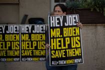 A woman holds a banner during a protest calling for the return of Israeli hostages held by Hama ...