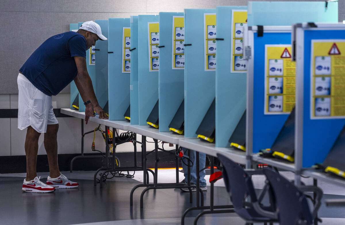 A voter makes his selections during Nevada's primary election day at the polls within the Summe ...