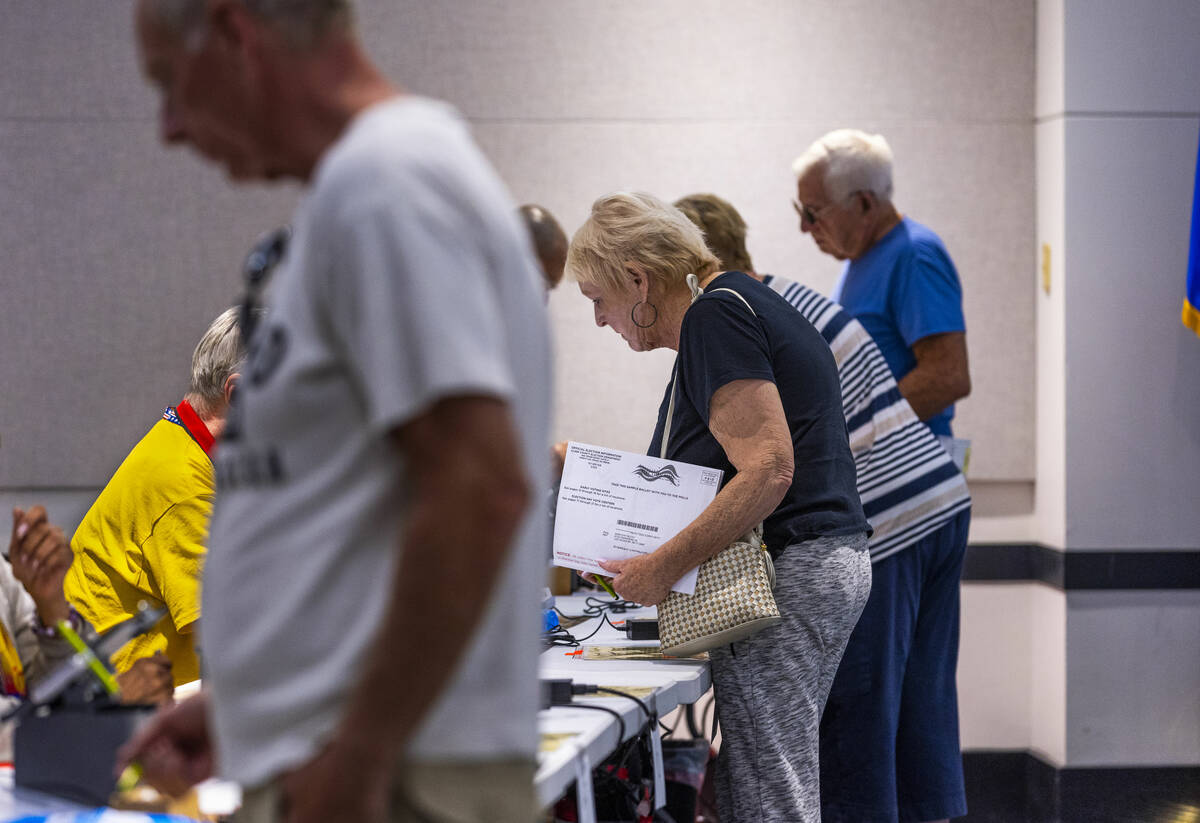 Voters sign in during Nevada's primary election day at the polls within the Summerlin West Libr ...