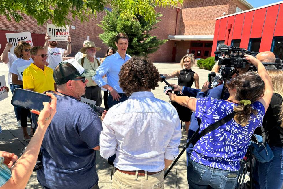 Nevada Senate hopeful Sam Brown speaks to reporters outside Reno High School after casting his ...