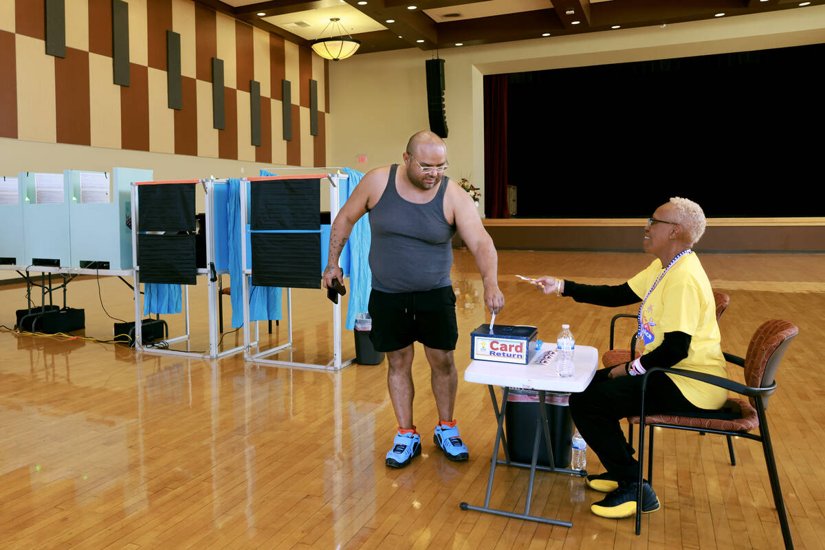 David Navarro of Las Vegas returns his card after voting at the Historic Fifth Street School in ...