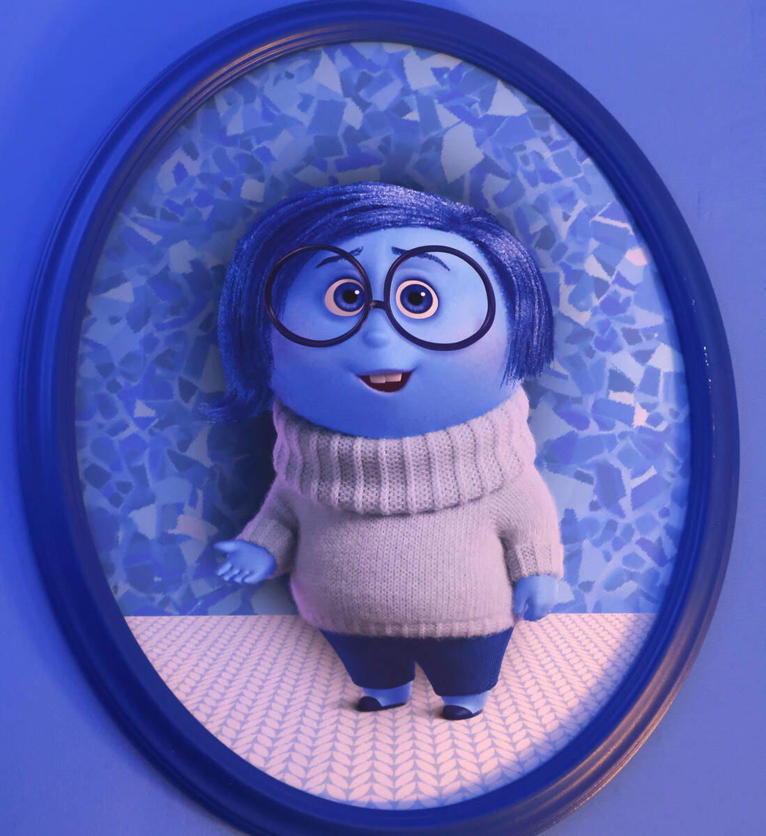 A photograph of Sadness is displayed inside a den at an "Inside Out 2"-themed propert ...