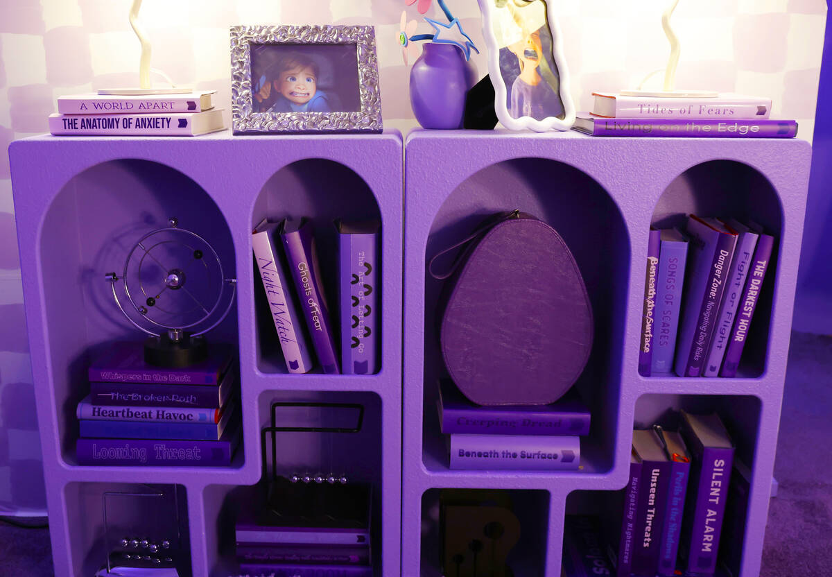 Books on fear are displayed inside a den with the theme of Fear at an "Inside Out 2"- ...