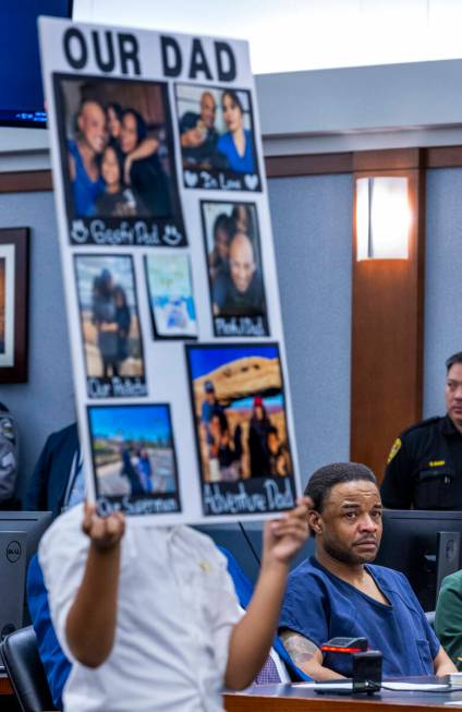 Jemarcus Williams looks at Aries Felix who is holding photos of his late father Nevada Highway ...