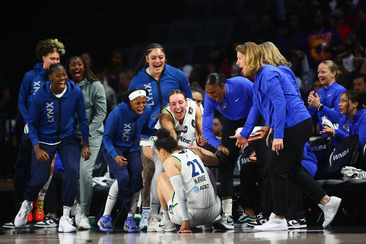 The Minnesota Lynx celebrate with their guard Kayla McBride (21) after she scored a three-point ...