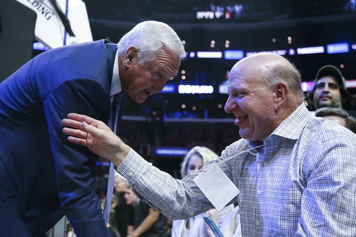 Steve Ballmer talks to Jerry West during an NBA basketball game between Los Angeles Clippers an ...