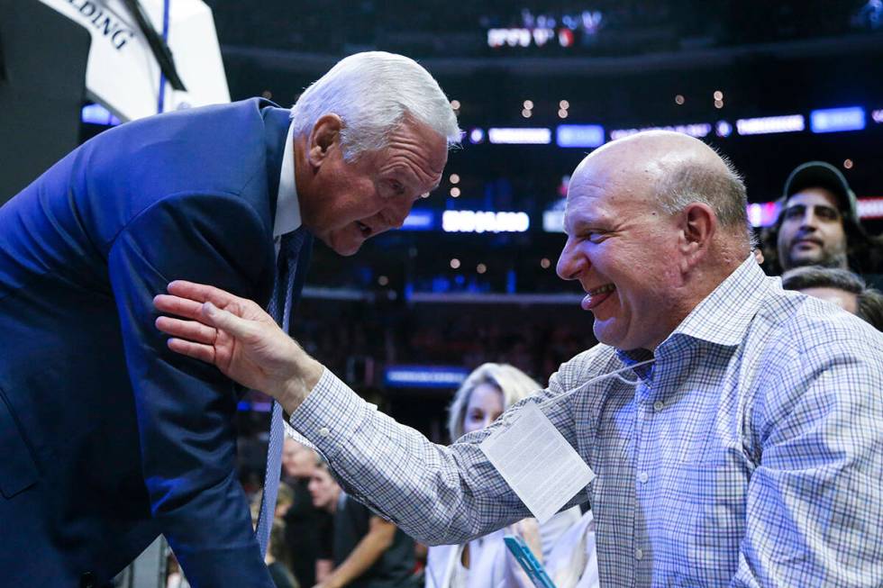 Steve Ballmer talks to Jerry West during an NBA basketball game between Los Angeles Clippers an ...