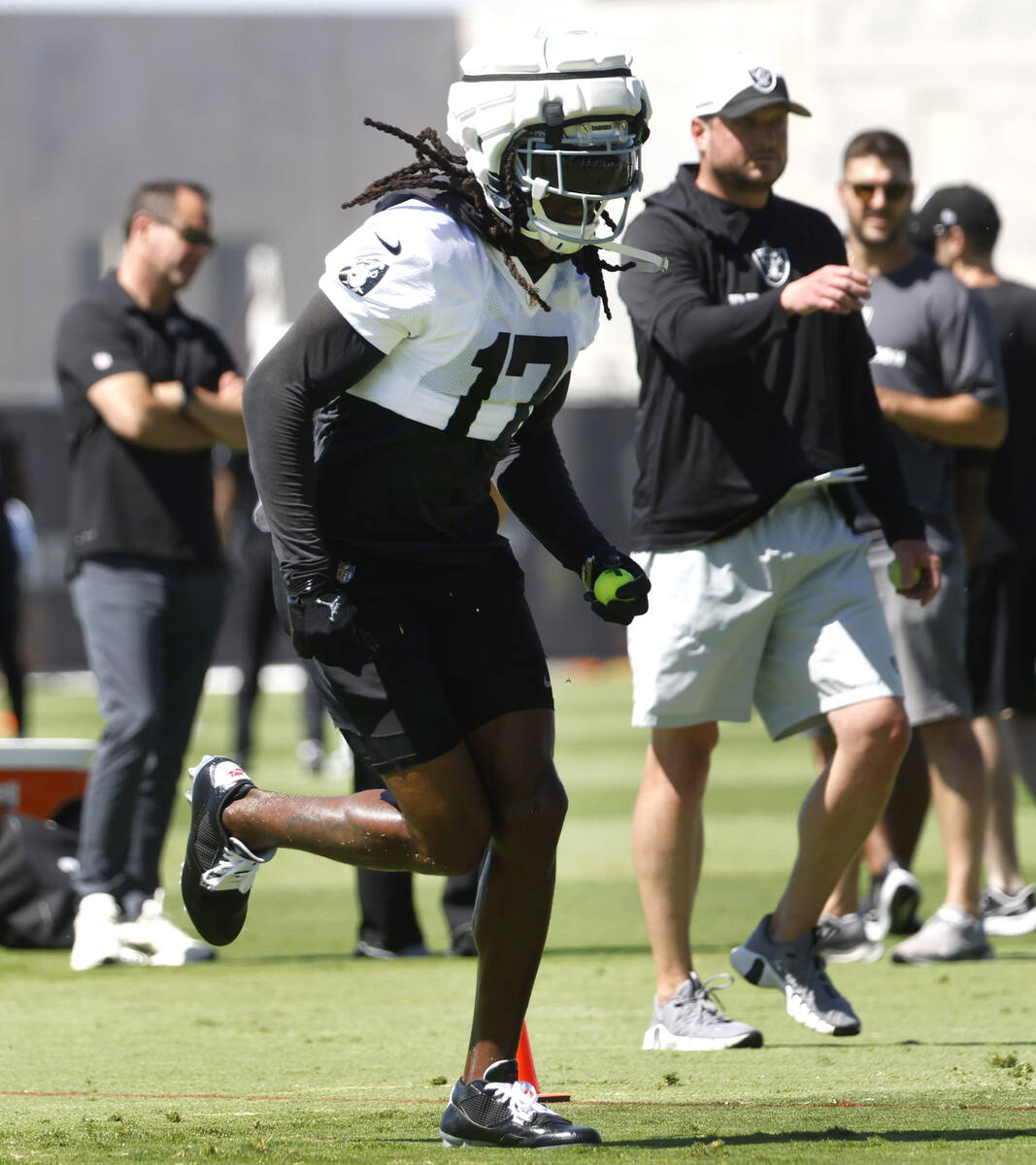 Raiders wide receiver Davante Adams (17) runs drills during an NFL football practice at the Int ...