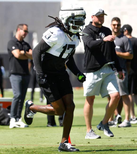 Raiders wide receiver Davante Adams (17) runs drills during an NFL football practice at the Int ...