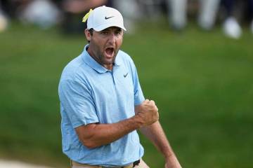 Scottie Scheffler pumps his fist after sinking a putt on the 18th green to win the Memorial gol ...