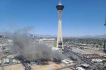 Smoke rises on the Strip from a building fire at the shuttered M&M Soul Food Cafe just south of ...