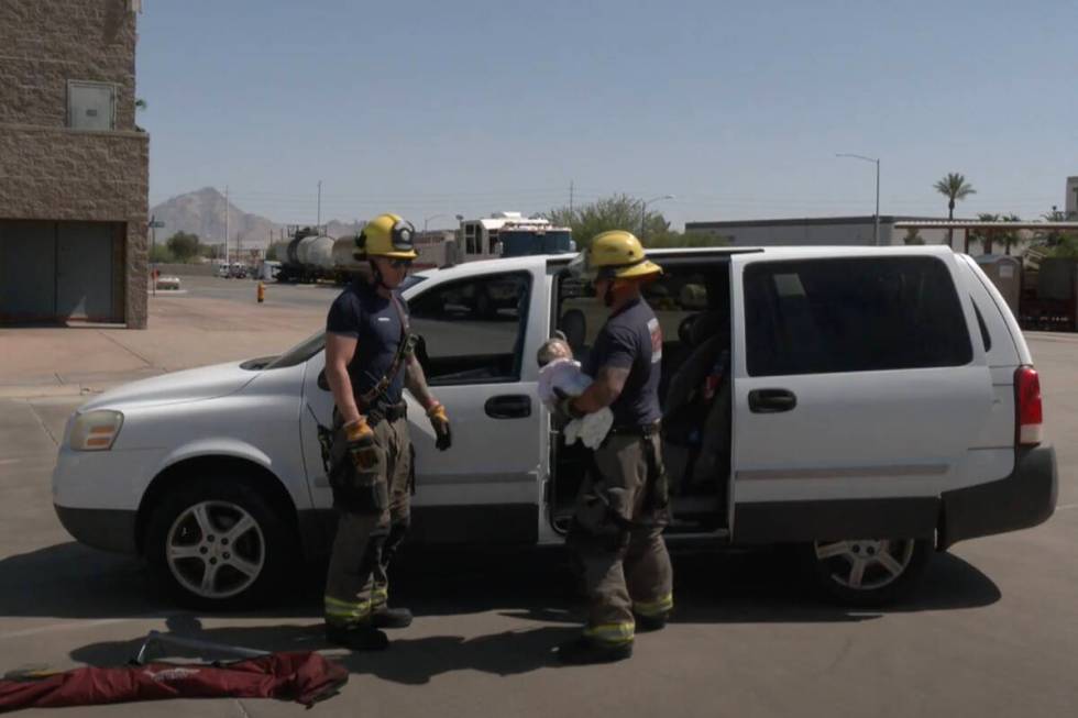 Henderson Fire Department firefighters demonstrate rescuing a child from a hot car during a hea ...