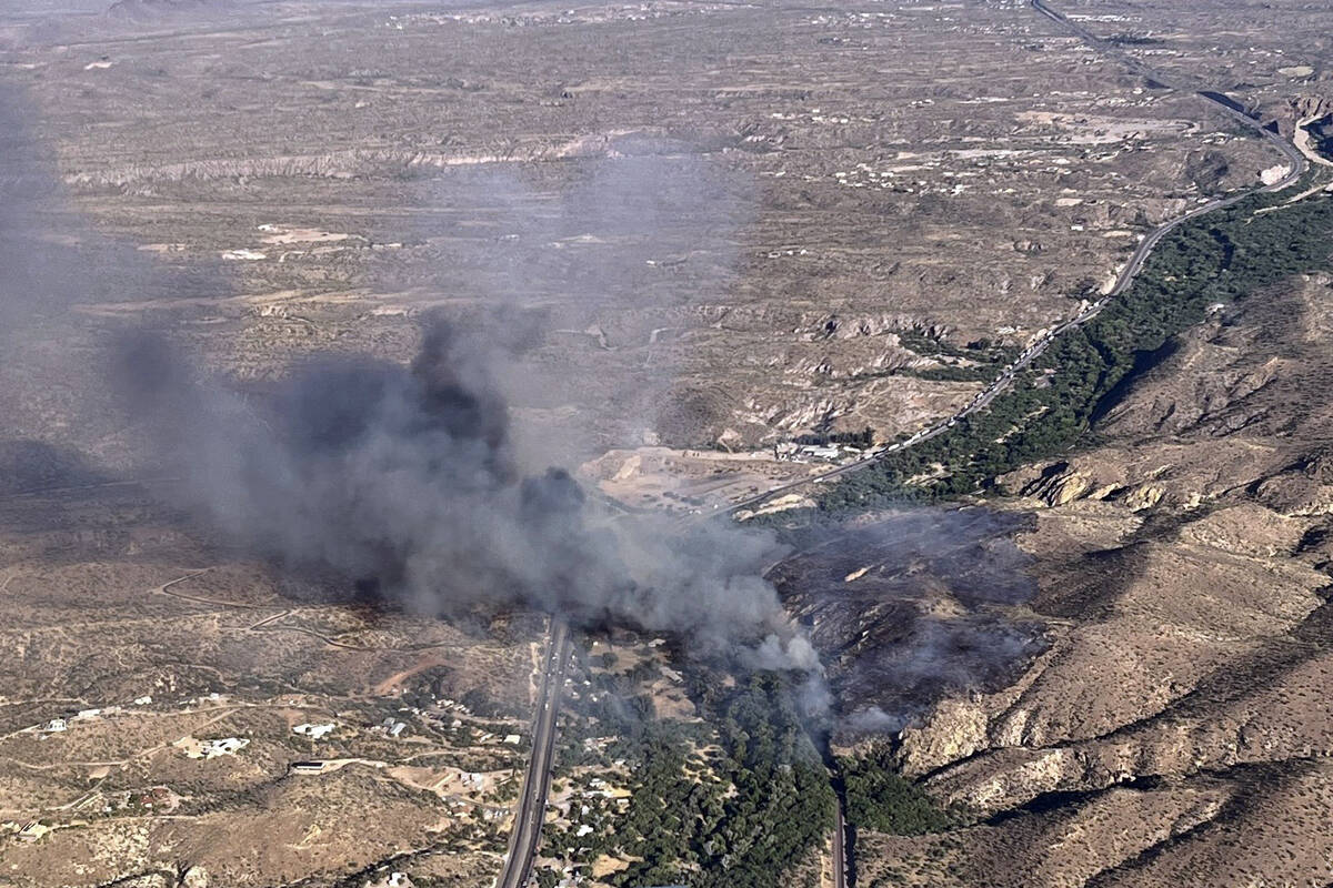 This image shows smoke from the Rose Fire burning southeast of Wickenburg, Ariz., Wednesday, Ju ...