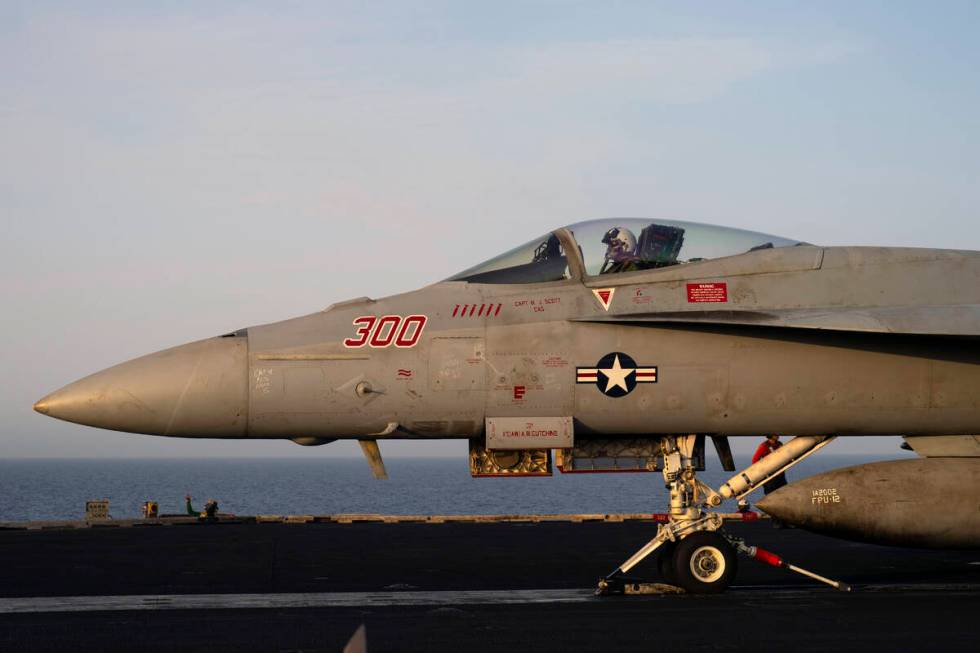 A fighter jet takes off from the USS aircraft carrier Dwight D. Eisenhower, also known as 'IKE' ...