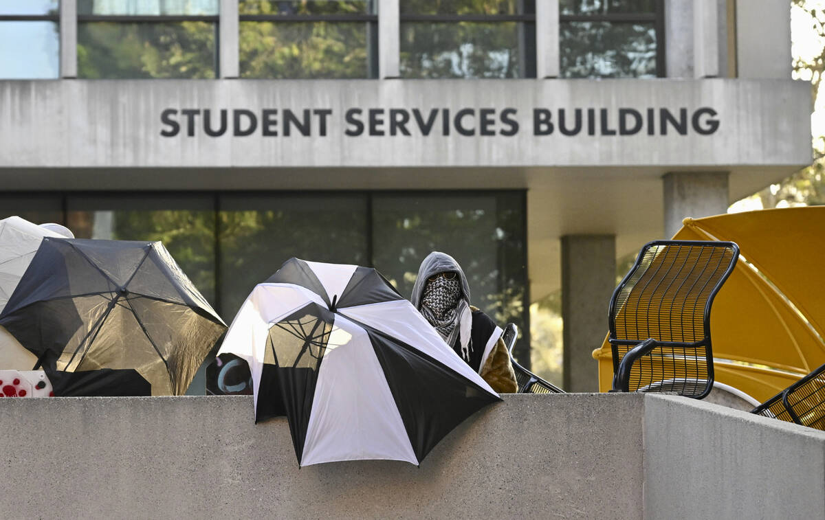 Pro-Palestinian student protesters barricade the entrance to the student services building whil ...