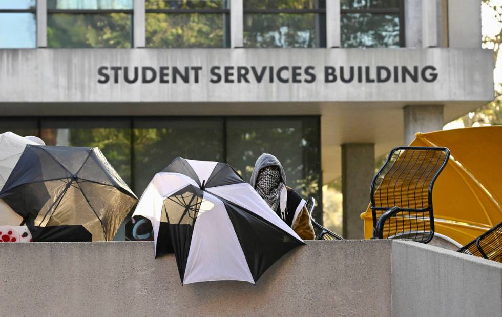 Pro-Palestinian student protesters barricade the entrance to the student services building whil ...