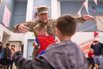 Maj. Beau Vinatieri gets a big hug from son's Jeau, 10, and Keaul, 8, in a surprise ceremony at ...