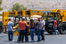 Attendees check out a JCB Loadall in the parking lot during an event at the Southern Nevada Tra ...