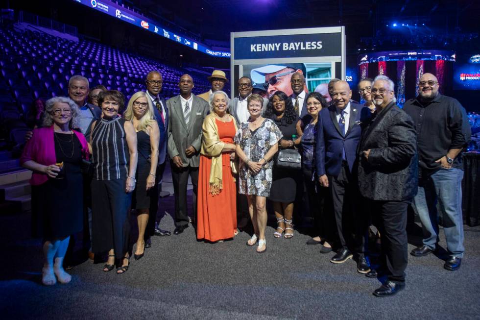 Kenny Bayless, six in from the left, takes a group photograph with extended family and friends ...