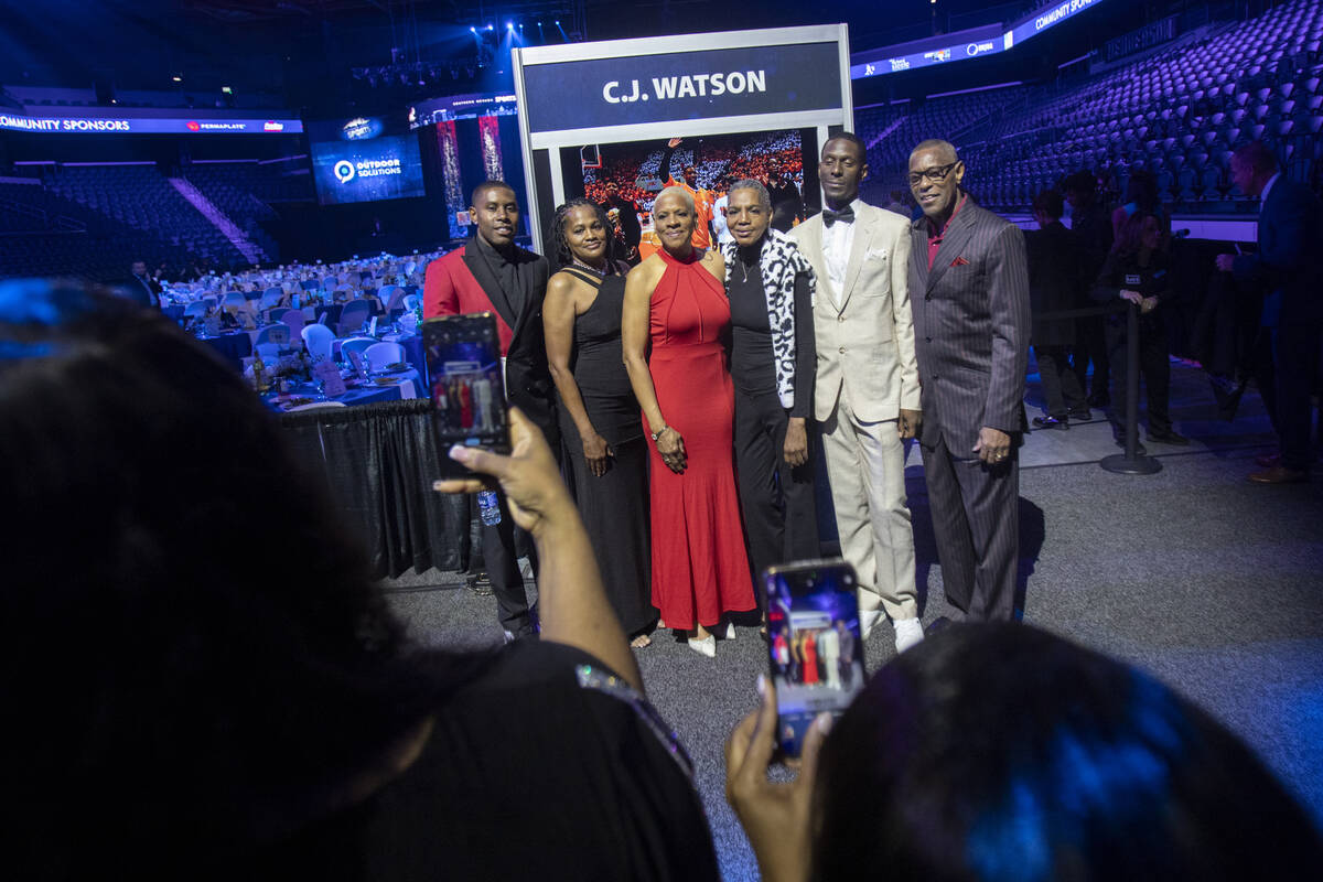 C.J. Watson, left, and members of his family take a photograph during the Southern Nevada Sport ...