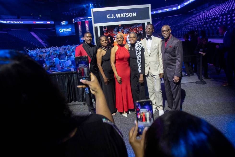 C.J. Watson, left, and members of his family take a photograph during the Southern Nevada Sport ...