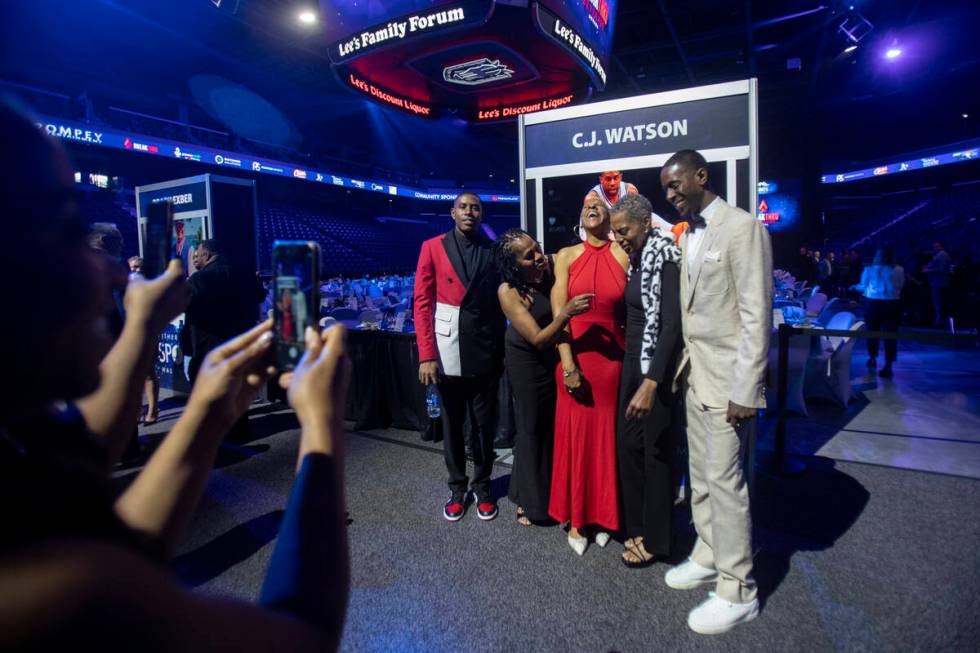 C.J. Watson, left, and members of his family prepare to take a group photograph during the Sout ...