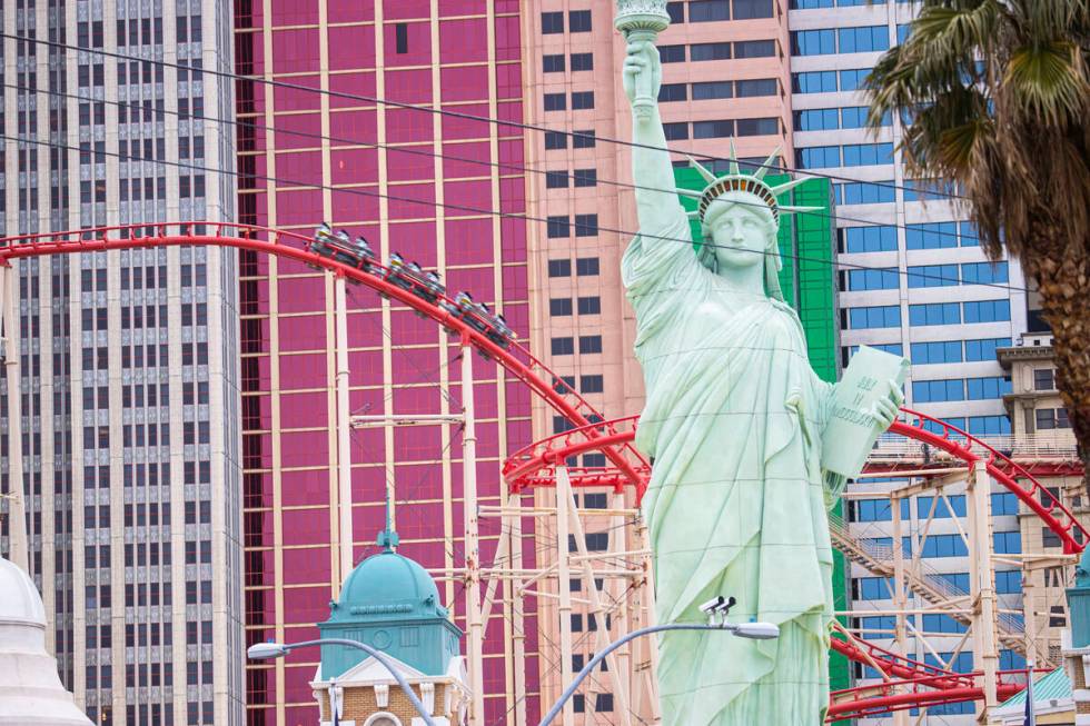 People ride on the Big Apple Coaster at New York-New York along the Las Vegas Strip on Thursday ...