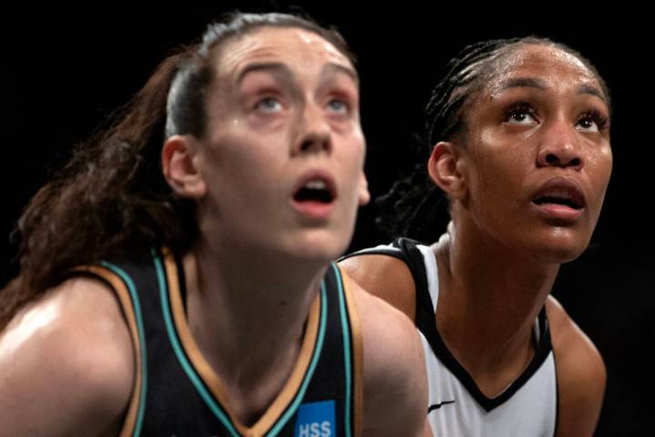 New York Liberty forward Breanna Stewart (30) and Las Vegas Aces forward A'ja Wilson (22) eye t ...