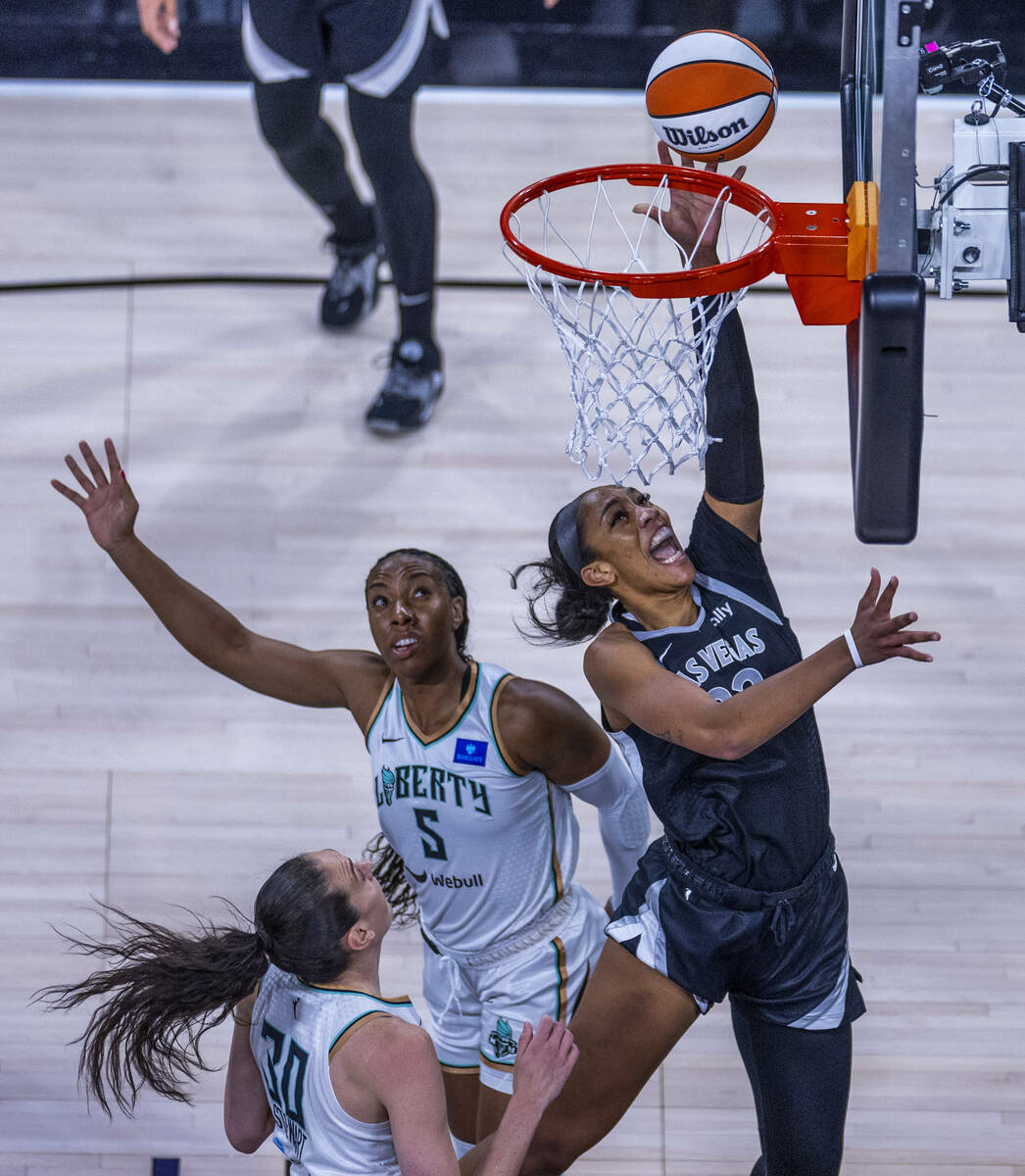 Aces center A'ja Wilson (22) gets inside of New York Liberty forward Kayla Thornton (5) and gua ...