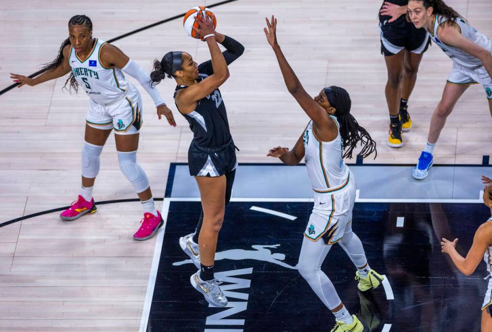 Aces center A'ja Wilson (22) elevates to shoot over New York Liberty forward Jonquel Jones (35) ...