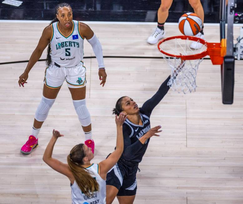 Aces forward Alysha Clark (7) goes up the the rim against New York Liberty guard Sabrina Ionesc ...