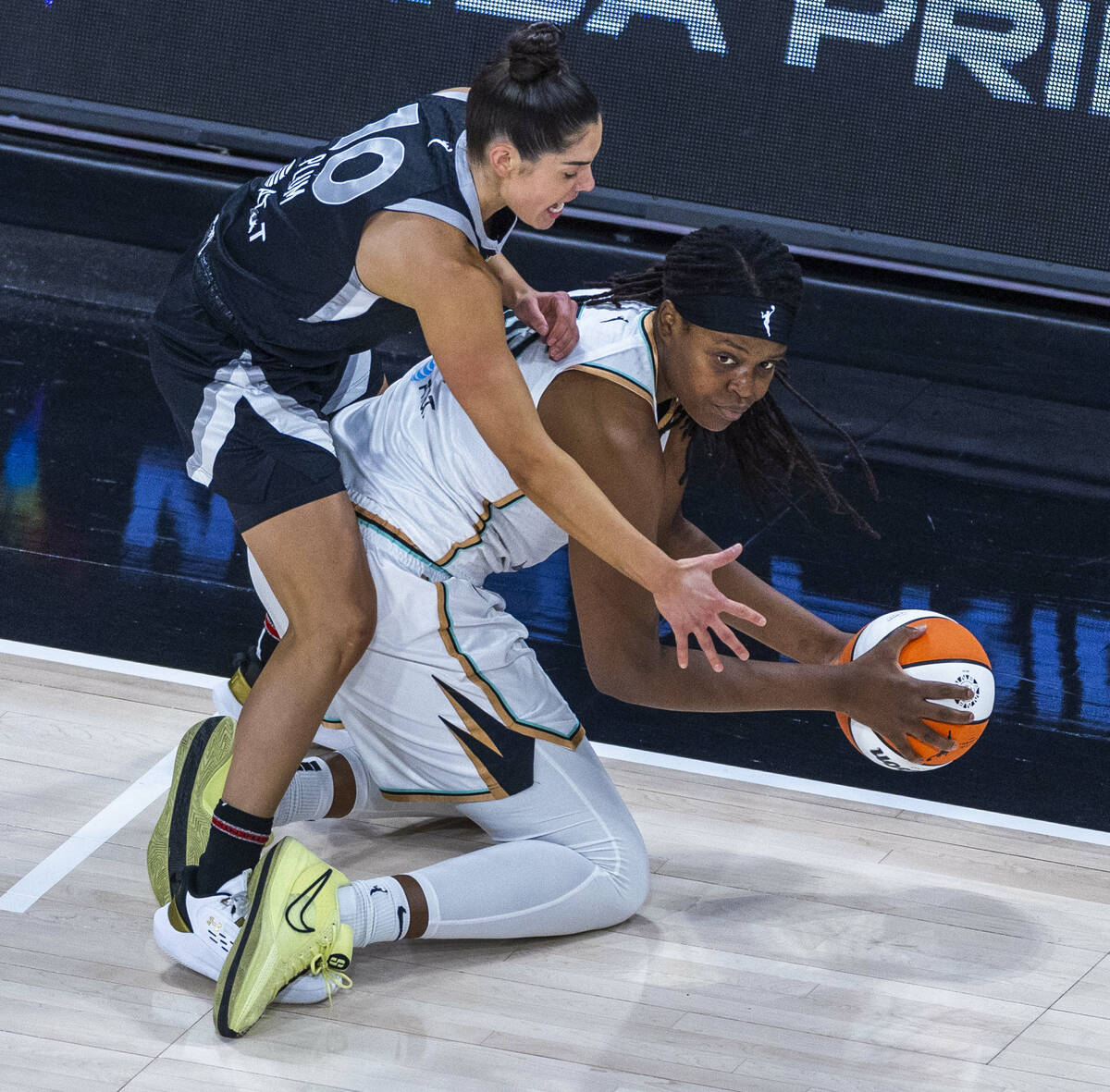 New York Liberty forward Jonquel Jones (35) looks to pass from her kness as Aces guard Kelsey P ...
