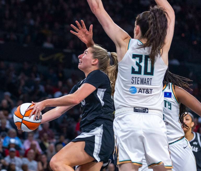 Aces guard Kate Martin (20) gets underneath the defense of New York Liberty forward Breanna Ste ...