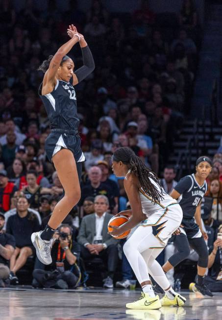 Aces center A'ja Wilson (22) jumps up expecting a shot by New York Liberty forward Jonquel Jone ...