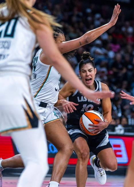 Aces guard Kelsey Plum (10) battles in the lane against New York Liberty forward Betnijah Laney ...