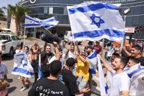 People wave Israeli flags as they celebrate after hostages who were kidnapped in a Hamas-led at ...