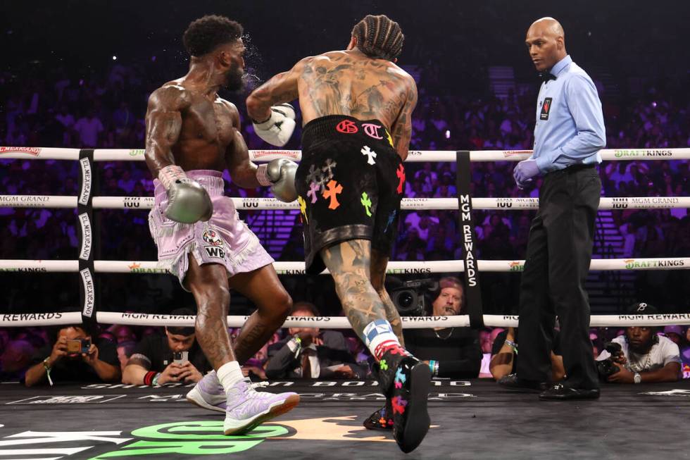 Gervonta “Tank” Davis, center, punches Frank Martin during a WBA world lightweigh ...