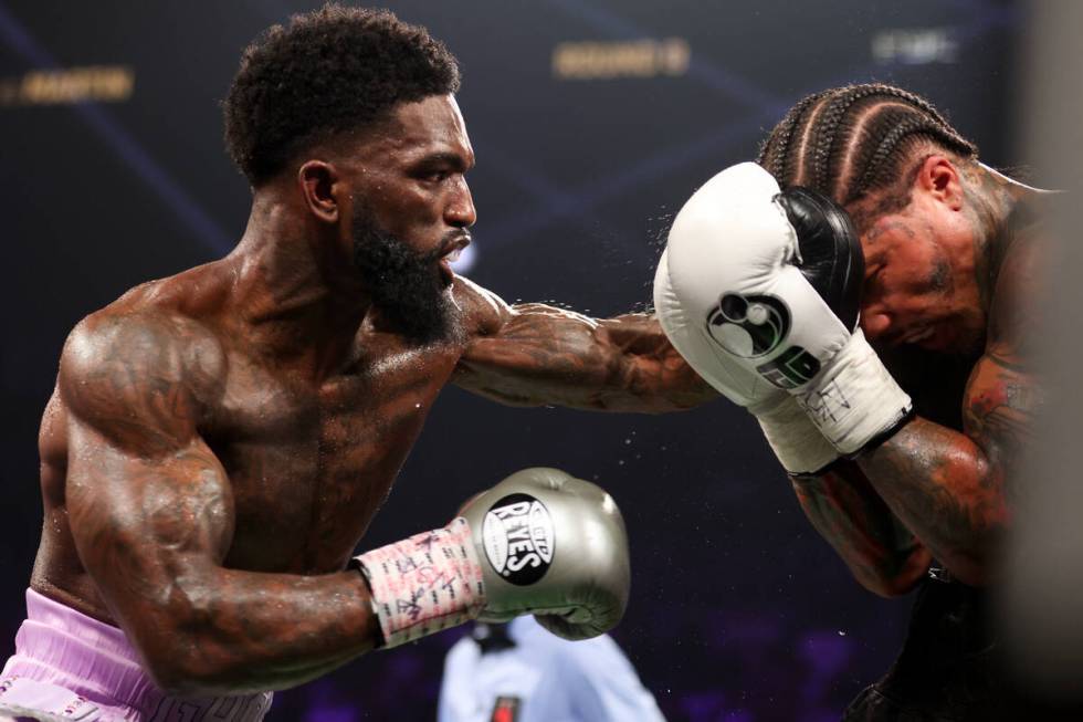 Gervonta “Tank” Davis, right, blocks a punch from Frank Martin during a WBA world ...