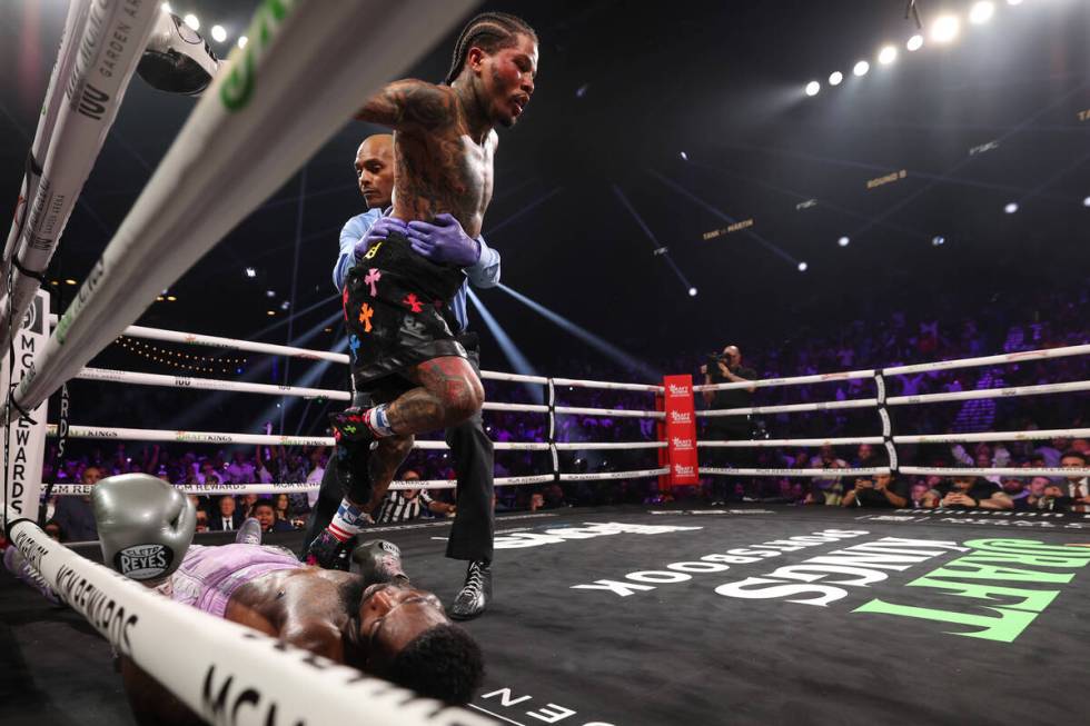 Gervonta “Tank” Davis walks over Frank Martin after knocking him out during a WBA ...